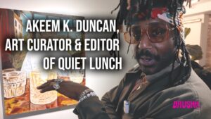 Akeem Duncan, Editor-in-Chief of Quiet Lunch, standing in his Flatiron headquarters, surrounded by curated artworks and collectibles.